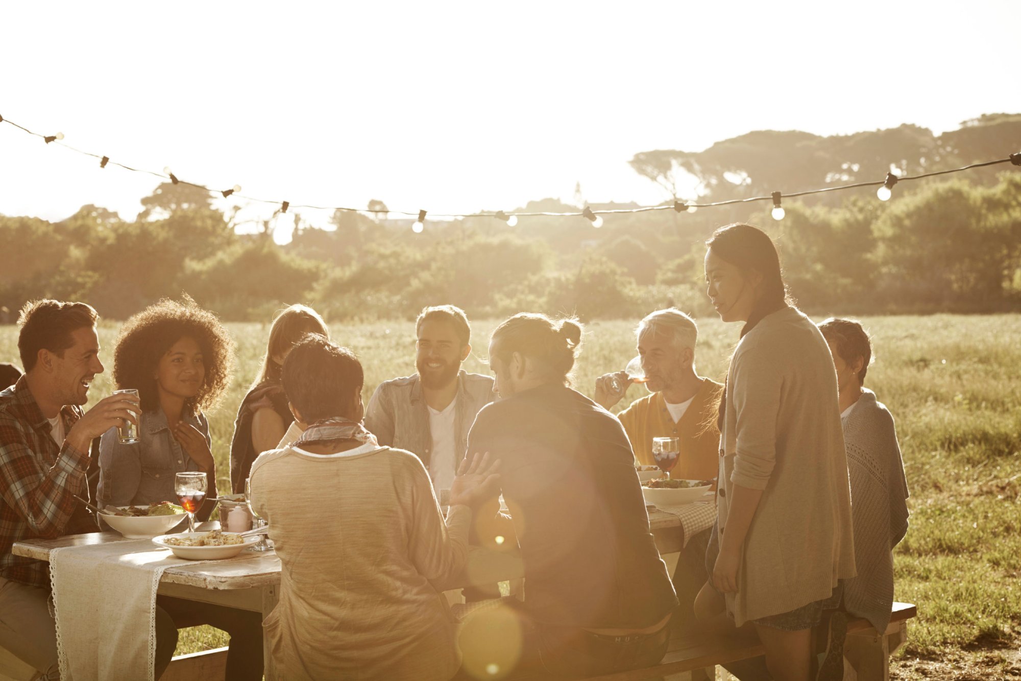People gathering around a table at Mayz
